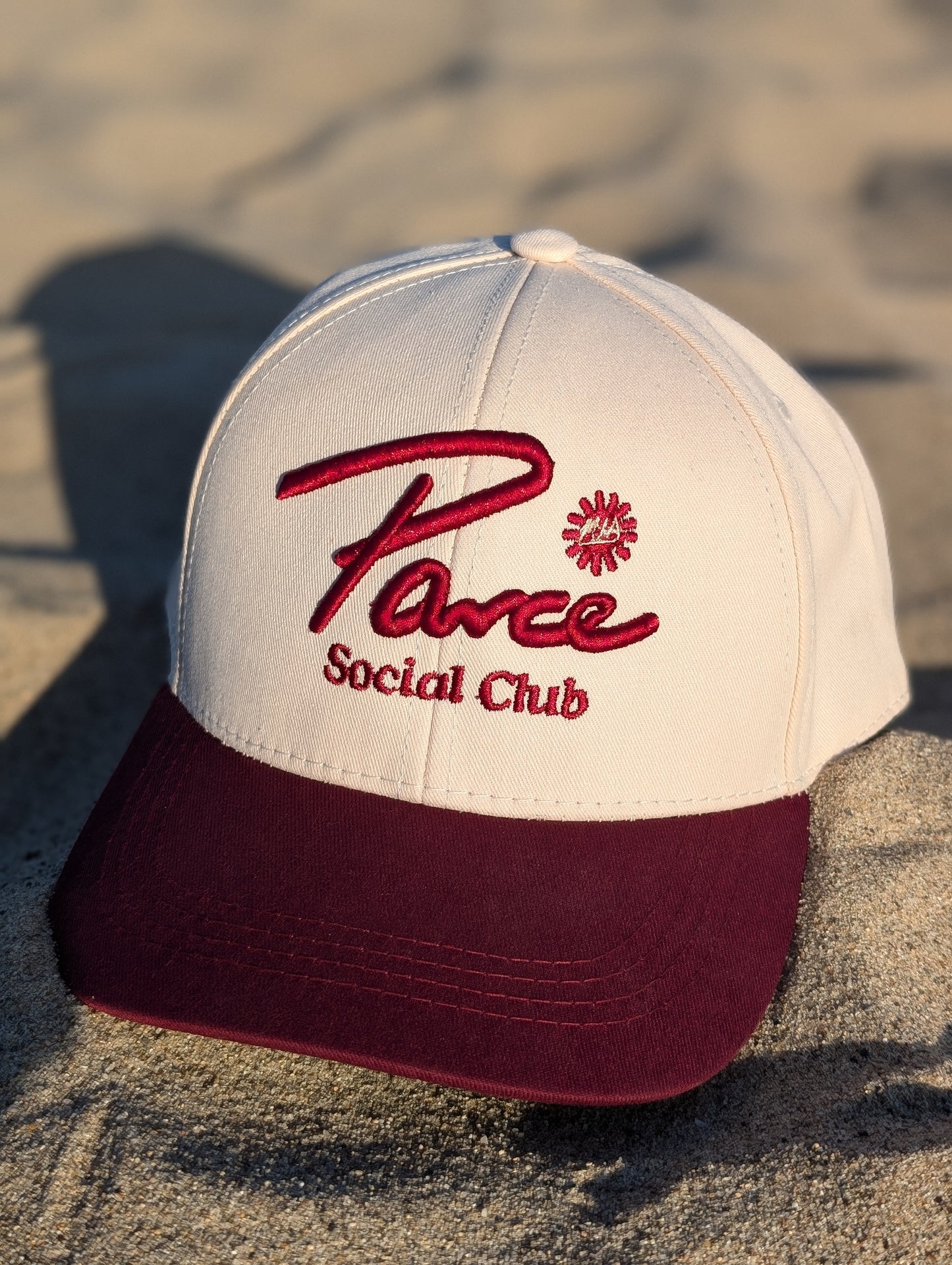 Detail of Parce Social Club cap showing curved brim and stitched embroidery