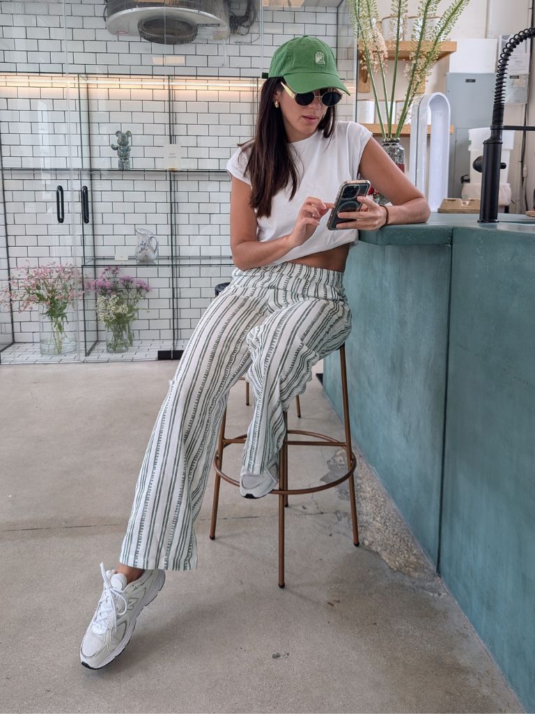 Tropical linen pants with green stripe detail – worn with white crop tee and sneakers at a café