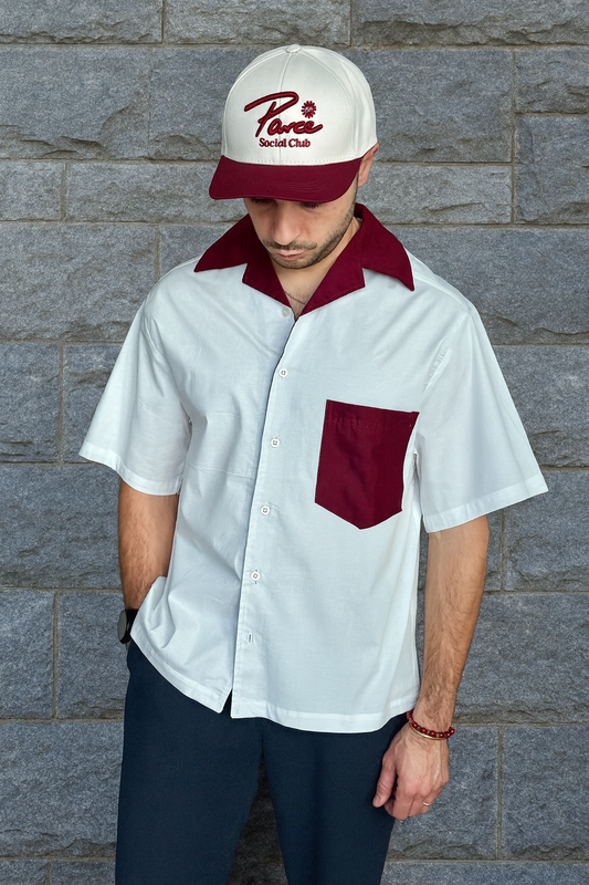 Man wearing the Palm Lanes Bowling Shirt by Parce Miami – white bowling-inspired resort shirt with burgundy collar and pocket, ethically made in Colombia.