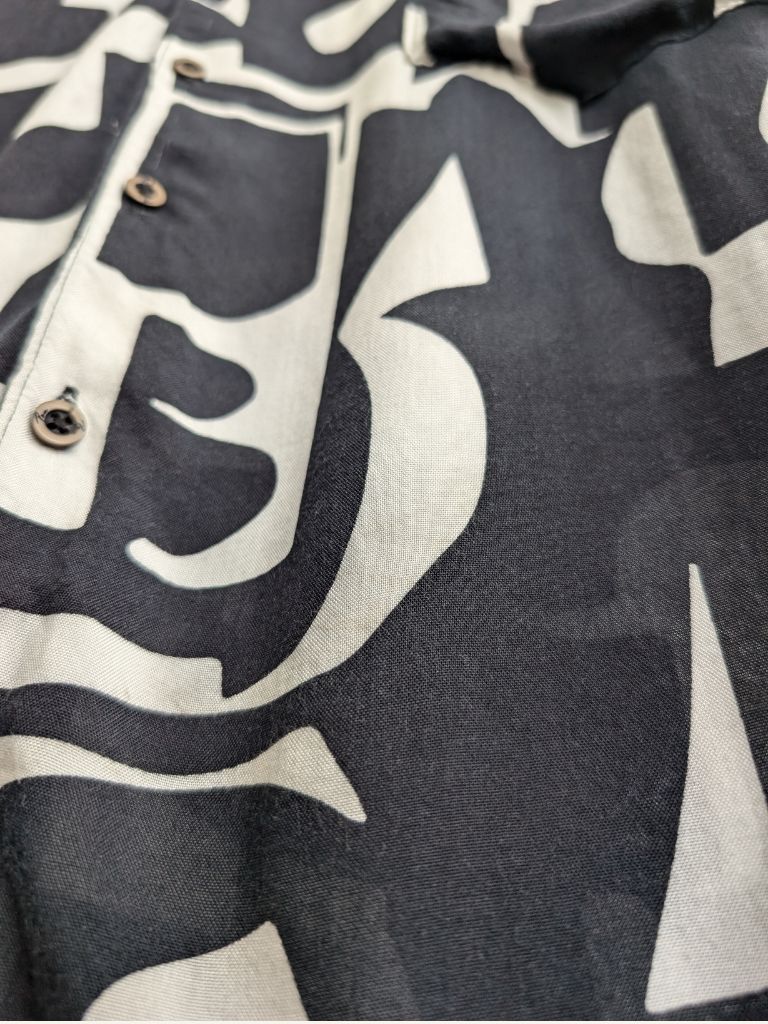 Detail shot of camp collar and short sleeve stitching on Black and White tropical shirt
