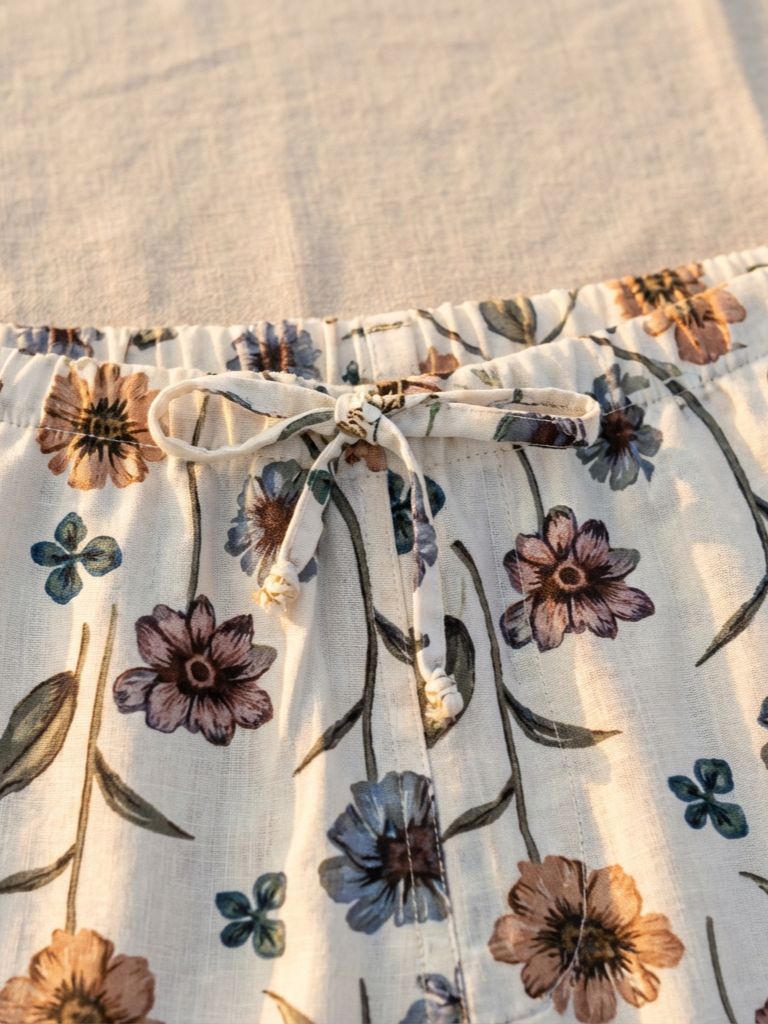 Floral patterned shorts with a drawstring on a textured fabric background