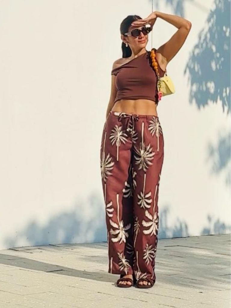 Close-up of Coco Boogaloo Pant showing mocha color, palm pattern, and drawstring waistband