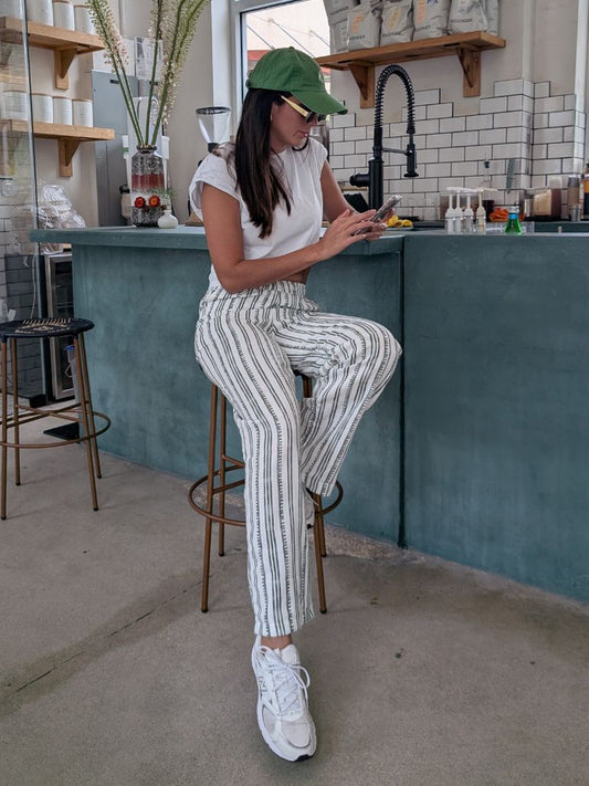Parce Green Linen Pant styled casually at a coffee bar – white linen pants with green stripes and sneakers